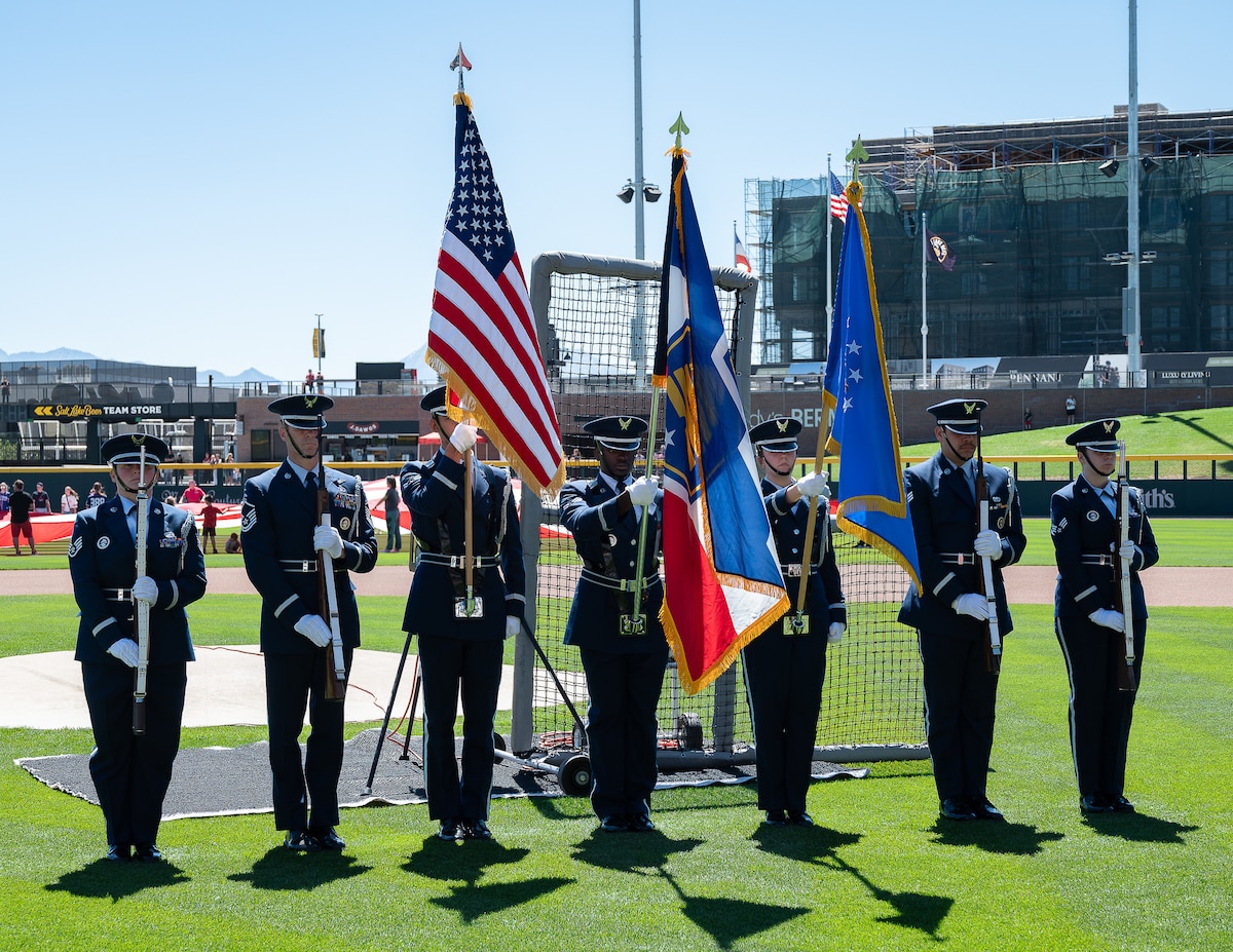 Members of a joint color guard composed of Utah National Guard and Hill Air Force Base service members present the colors during pregame ceremonies before an exhibition baseball game at The Ballpark at America First Square in South Jordan, Utah, June 13, 2025. The event brought together military members and community partners to promote resilience, mental health awareness and community support through the "In the Open: Strength Beyond the Uniform" initiative. (Utah National Guard photo by Master Sgt. Nicholas Perez)