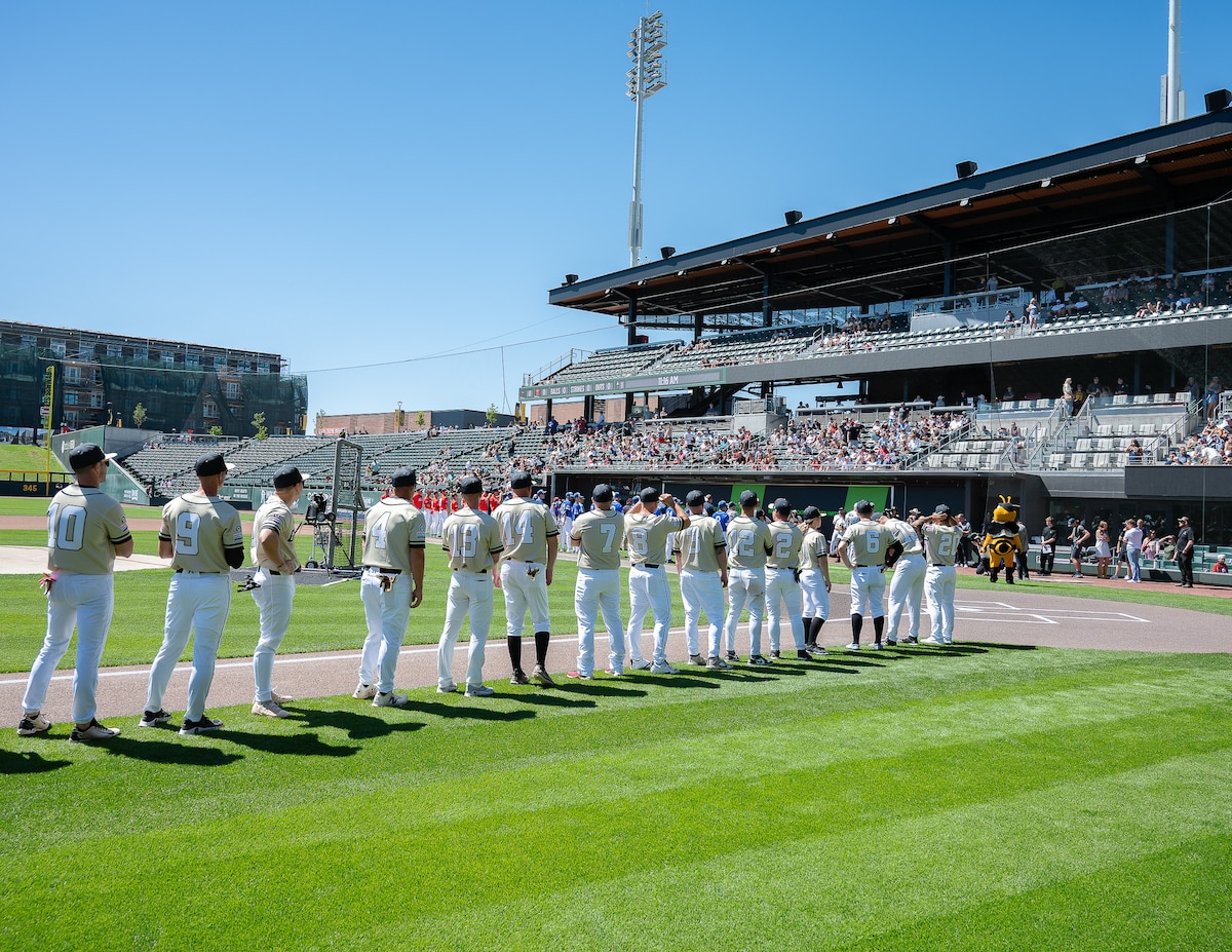 Participants gather on the field before an exhibition baseball game between the Utah National Guard and Hill Air Force Base at The Ballpark at America First Square in South Jordan, Utah, June 13, 2025. The event connected service members, community leaders and supporters through sports and conversations about resilience. (Utah National Guard photo by Master Sgt. Nicholas Perez)