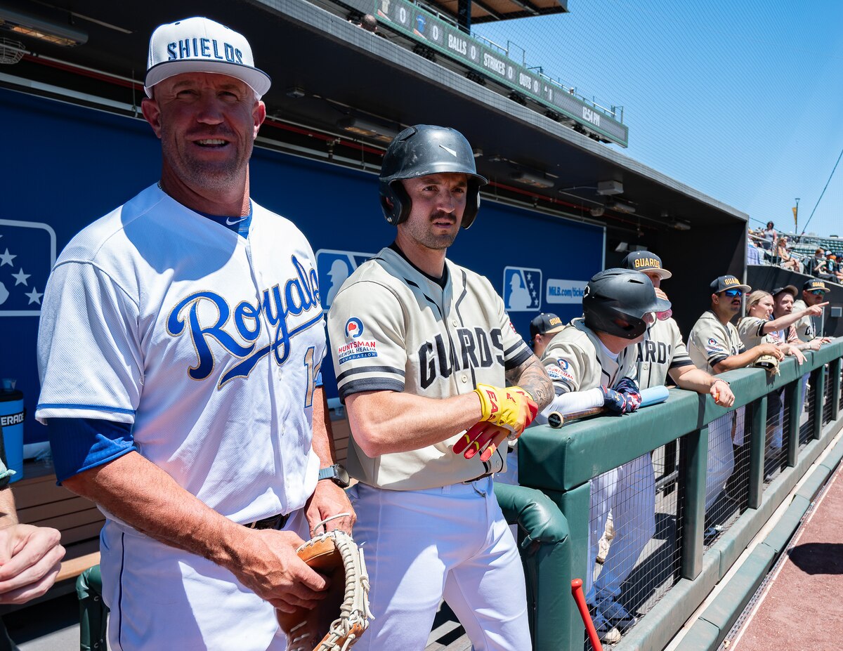 Retired Major League Baseball catcher and Utah National Guard team coach John Buck (left) stands with members of the Utah National Guard baseball team in the dugout before an exhibition game against Hill Air Force Base at The Ballpark at America First Square in South Jordan, Utah, June 13, 2025. The game followed the "In the Open: Strength Beyond the Uniform" resilience event, which promoted mental health awareness, community engagement and service member well-being. (Utah National Guard photo by Master Sgt. Nicholas Perez)