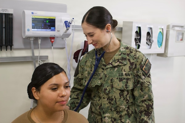 Hospitalman Chloe Gerimonte (right) provides care to a patient at the Adult Medical Care Clinic at Navy Medicine Readiness and Training Command Twentynine Palms aboard Marine Corps Air Ground Combat Center Twentynine Palms, California, April 1, 2026. Gerimonte serves as a Hospital Corpsman at the clinic, supporting patient care and medical readiness for Sailors and Marines. (U.S. Navy photo by Hospital Apprentice Evelyn Zermeno, NH/NMRTC Twentynine Palms public affairs).