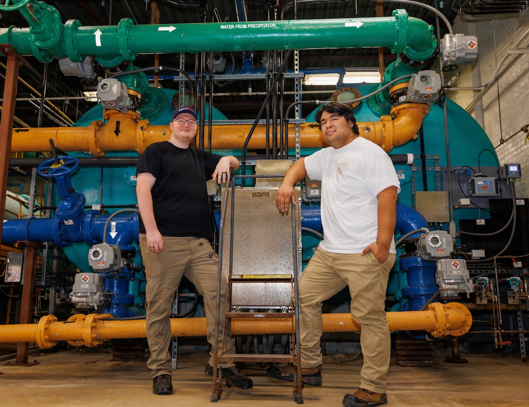 Brian Ervine, left, a utilities system operator assistant, and Bryan Harlan, a water plant operator, pose for a photo at the Mainside Water Treatment Plant in Triangle, Virginia, June 6, 2026. The Mainside Water Treatment Plant treats approximately 1 million gallons of drinking water each day to support Marines, families, civilian employees, and visitors aboard Marine Corps Base Quantico. (U.S. Marine Corps Photo by Lance Cpl. Federico Marquez)