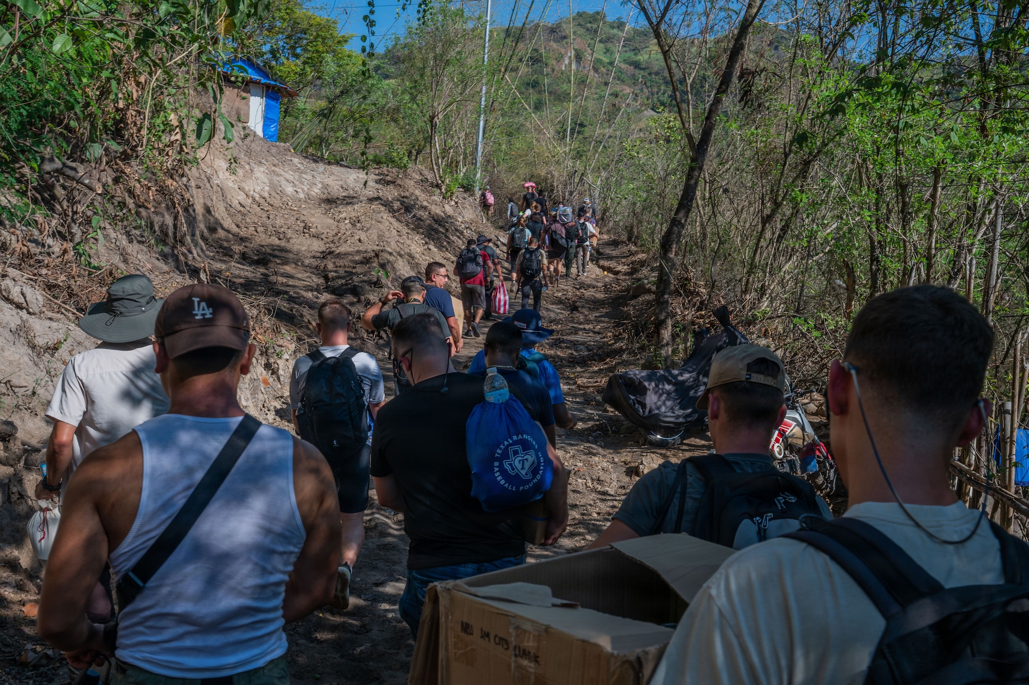 U.S. Air Force and Philippine Air Force Airmen walk toward Haduan Village during a humanitarian outreach event in the Philippines, May 20, 2026. The event highlighted the 21st Air Expeditionary Wing’s commitment to community involvement, strengthening ties with local organizations and residents. (U.S. Air Force photo by Senior Airman Alondra Cristobal Hernandez)