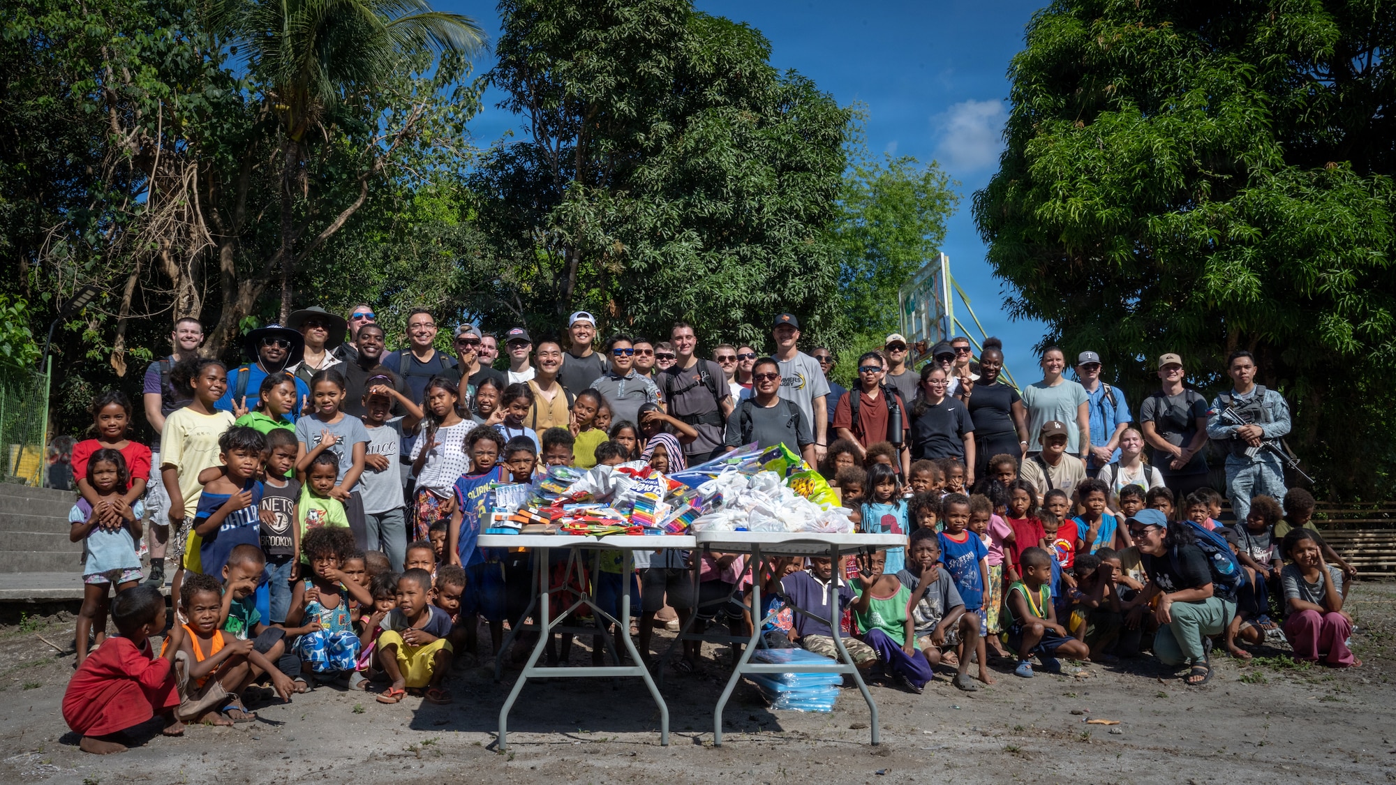 U.S. Airmen assigned to the 21st Air Expeditionary Wing and Philippine Air Force airmen assigned to the 600th Air Base Group pose for a group photo during a community outreach event with children in Haduan, Philippines, May 20, 2026. The bilateral event reinforced the enduring partnership between the United States and the Philippines by fostering mutual respect and strengthening connections with local communities. (U.S. Air Force photo by Senior Airman Adrien Tran)