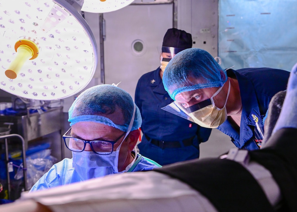 260610-N-XW565-1069 U.S. Navy Lt. Cmdr. James O'Loughlin, left, assigned to Fleet Surgical Team (FST) 5, and Senior Chief Hospital Corpsman William Meyers, assigned to Wasp-class amphibious assault ship USS Essex (LHD 2), perform a routine surgery while underway, June 10, 2026. Essex is underway in the U.S. 3rd Fleet area of operations. An integral part of the U.S. Pacific Fleet, U.S. 3rd Fleet leads naval forces in the Indo-Pacific and provides the realistic, relevant training necessary to execute the U.S. Navy's role across the full spectrum of military operations. U.S. 3rd Fleet works together with allies and partners to advance freedom of navigation and overflight, the rule of law and other principles that underpin security for the Indo-Pacific region.  (U.S. Navy photo by Mass Communication Specialist Seaman Ivan A. Garcia)