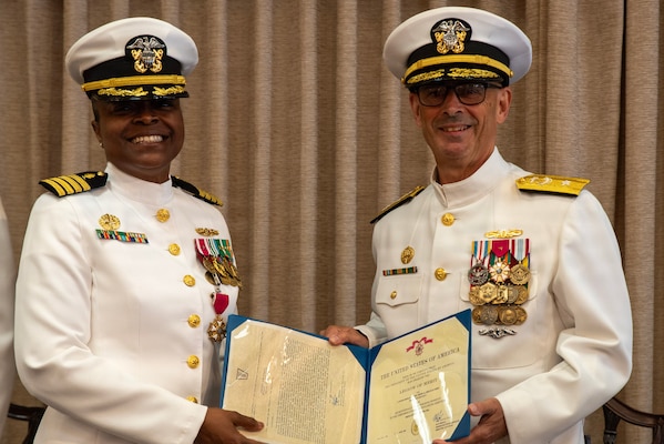 Rear Adm. Robert Hawkins, director of Defense Health Network Atlantic and commander of Naval Medical Forces Atlantic, right, presents the Legion of Merit to Capt. Rona Green during her retirement ceremony aboard Naval Station Newport, on June 10, 2026. (U.S. Navy photo by Mass Communication Specialist 1st Class Jacob Allison).