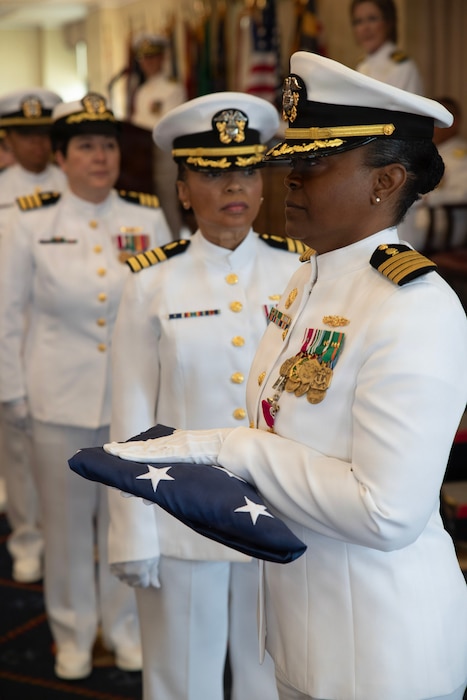 Capt. Rona Green receives the national ensign during her retirement ceremony aboard Naval Station Newport, R.I., June 10, 2026. Green served the Navy for 37 years of dedicated and honorable service. (U.S. Navy photo by Mass Communication Specialist 1st Class Jacob Allison)