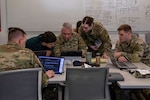 U.S. Army National Guard Soldiers and a civilian cybersecurity specialist collaborate at a workstation to mitigate a simulated network breach during Exercise Cyber Tatanka 2026 in Lincoln, Nebraska, June 9, 2026. The fifth annual exercise brought together 243 defenders from public utilities, health care facilities, law enforcement and financial institutions to defend critical regional infrastructure. Photo by Staff Sgt. Gauret Stearns.