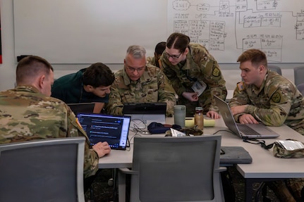U.S. Army National Guard Soldiers and a civilian cybersecurity specialist collaborate at a workstation to mitigate a simulated network breach during Exercise Cyber Tatanka 2026 in Lincoln, Nebraska, June 9, 2026.