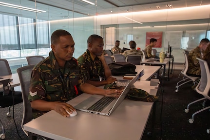 Service members from the Armed Forces of Tanzania analyze defensive data logs on a laptop during the live-fire phase of Exercise Cyber Tatanka 2026 at Kiewit Hall on the University of Nebraska-Lincoln campus in Lincoln, Nebraska, June 9, 2026.