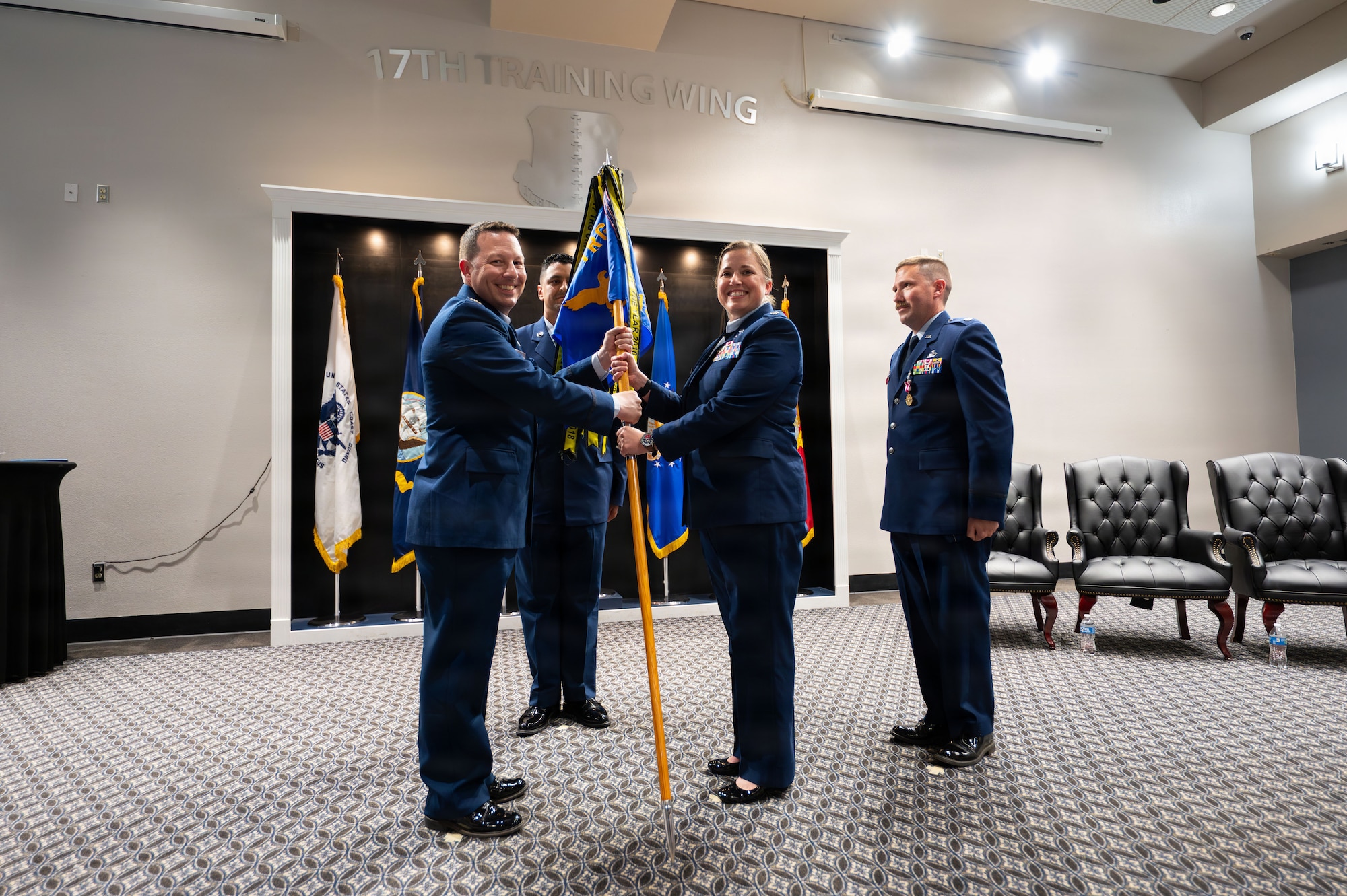 A unit guidon is exchanged between two service members