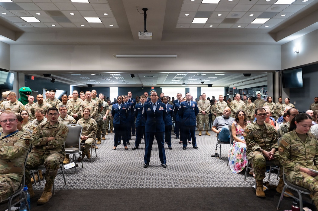 Uniformed service members stand in formation
