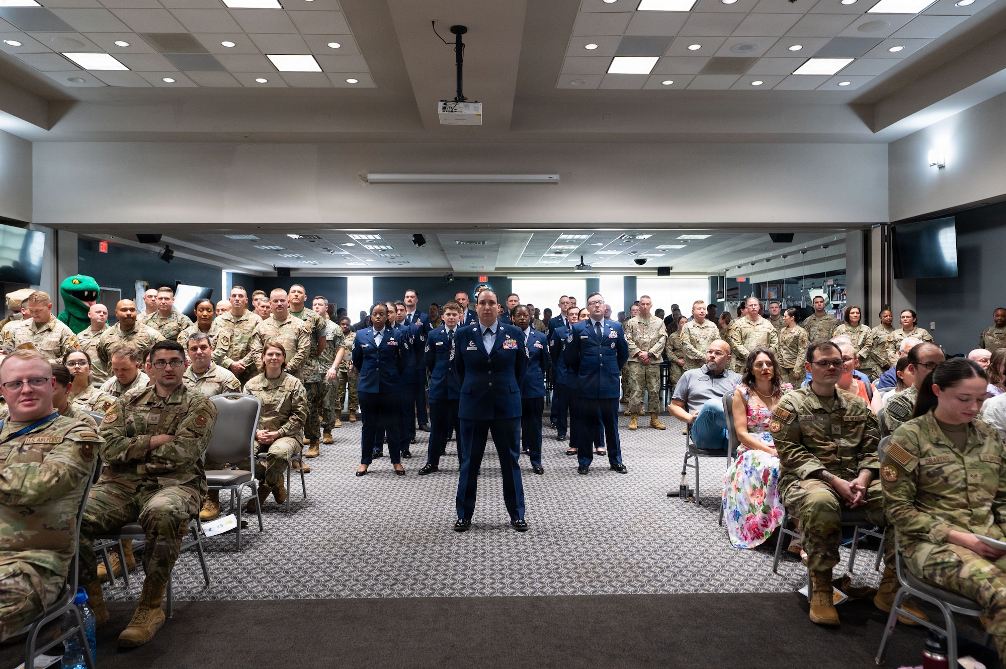 Uniformed service members stand in formation