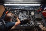 Keith Williams, 502d Logistic Readiness Squadron heavy mobile equipment mechanic, works on an engine head for a vehicle at Joint Base San Antonio-Fort Sam Houston, Texas, June 17, 2026. The members of the 502d LRS vehicle maintenance section work to ensure JBSA’s entire 3,125 vehicle fleet is up and running. (U.S. Air Force photo by Joshua J. Garcia)