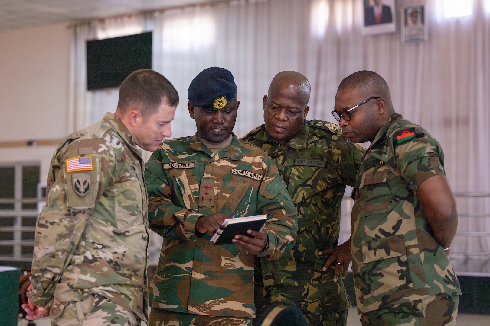 Participants at the Domestic Response Workshop watch videos of previous floods in Zambia at the Zambia Army Headquarters in Lusaka, Zambia, June 9, 2026.