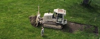 Soldiers from the Illinois Army National Guard’s 123rd Engineer Battalion do grubbing operations at the Crestwood Armory as they install a running track as part of their annual training in June 2026.
