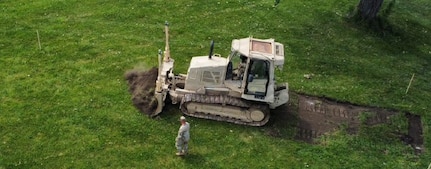 Soldiers from the Illinois Army National Guard’s 123rd Engineer Battalion do grubbing operations at the Crestwood Armory as they install a running track as part of their annual training in June 2026.