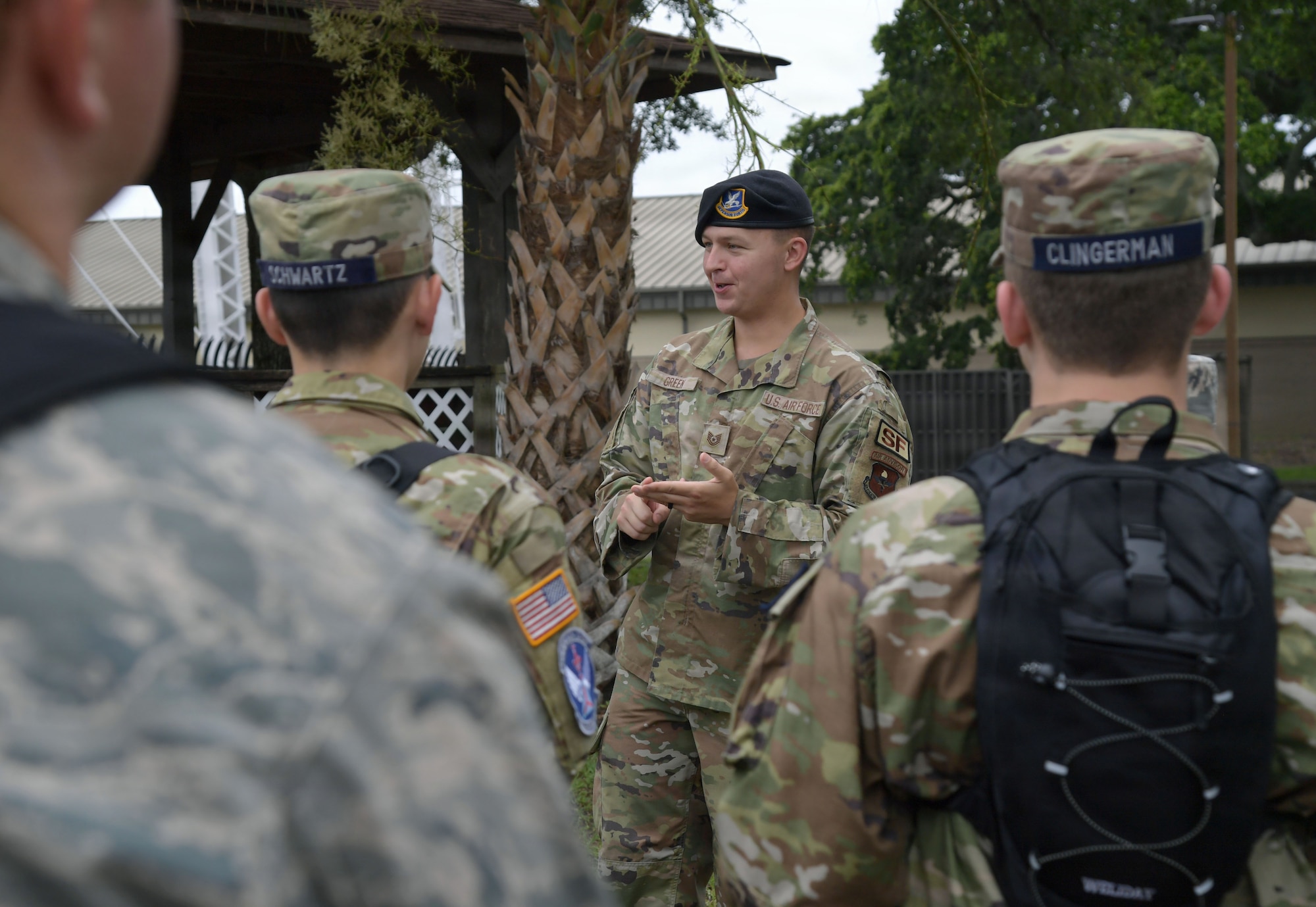 A man in military uniform speaks to a group of civil air patrol cadets.