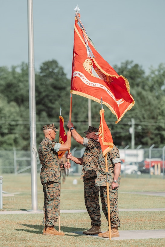 U.S. Marine Corps Sgt. Maj. Ralph C. Vargas, Marine Forces Special Operations Command sergeant major  brings the MARSOC colors to Maj. Gen. Peter D. Huntley during the change of command ceremony on Marine Corps Base Camp Lejeune, North Carolina, June 12, 2026. During the ceremony, Maj. Gen. Peter D. Huntley relinquished command of MARSOC to Maj. Gen. Michael A. Brooks, a tradition symbolizing the transfer of authority, responsibility and accountability of the Marines and Sailors under his charge. (U.S. Marine Corps photo by Lance Cpl. Jared Saul)