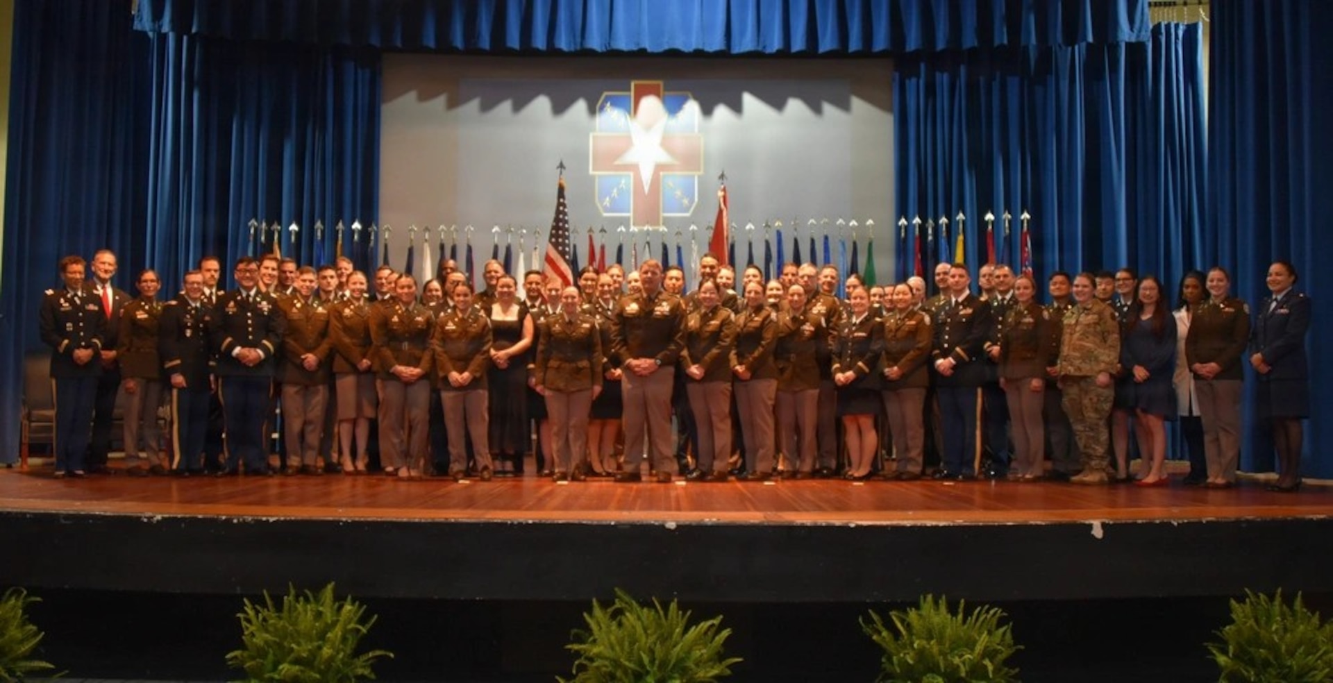 Graduates, family members, and leadership gather during the Womack Army Medical Center Graduate Medical and Graduate Dental Education commencement ceremony at Fort Bragg, N.C., June 5, 2026. The annual event honored a new class of Army physicians, dentists, nurses, and social workers who completed training in nationally accredited programs, preparing them to support military medicine missions worldwide.