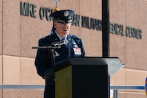 Col. Jason Glynn speaks at a podium.