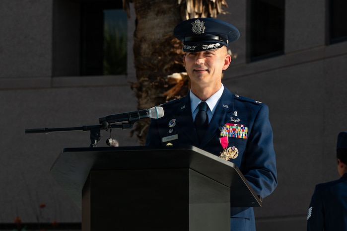 Col. Eric Phillips speaks at a podium.
