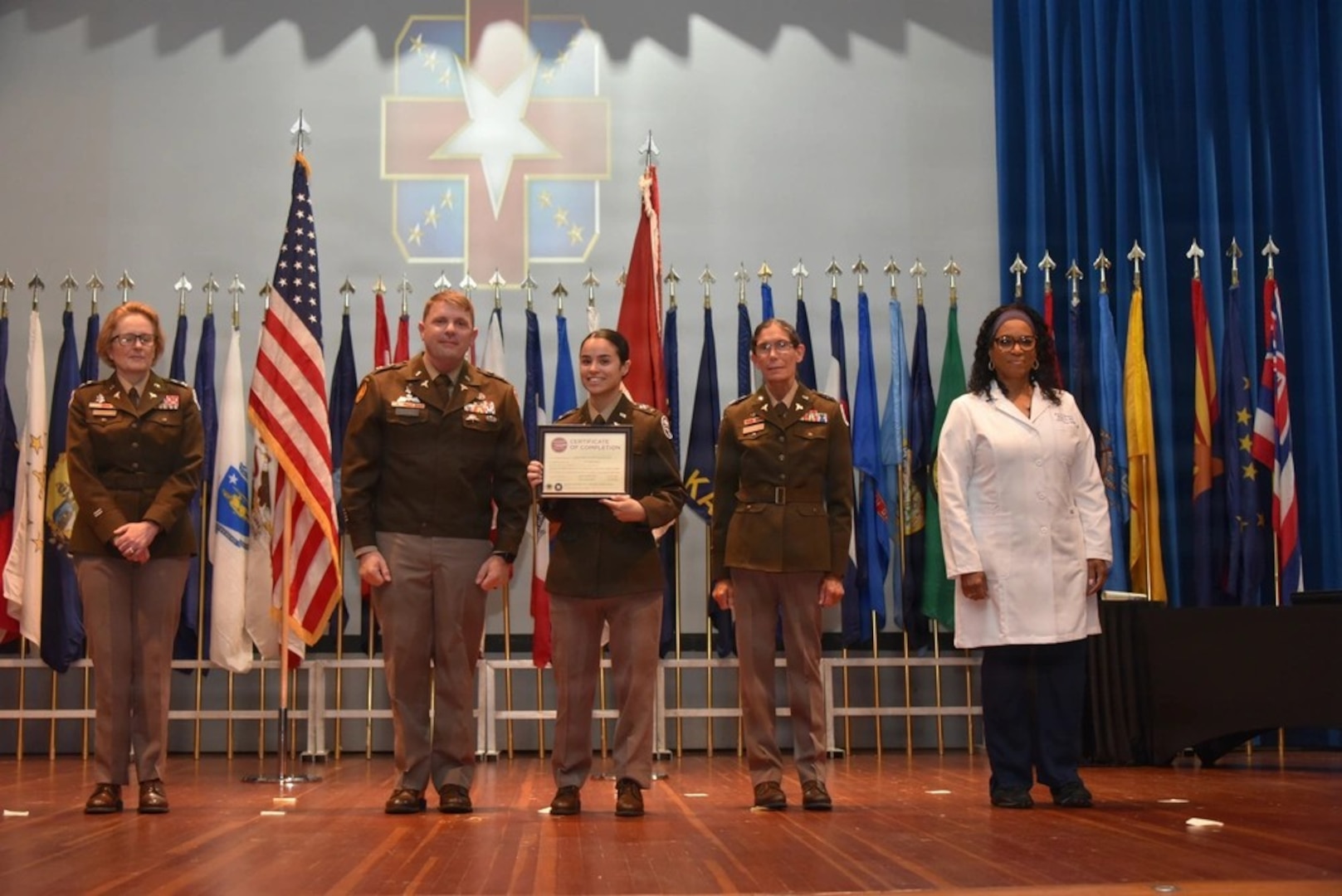 Graduates, family members, and leadership gather during the Womack Army Medical Center Graduate Medical and Graduate Dental Education commencement ceremony at Fort Bragg, N.C., June 5, 2026. The annual event honored a new class of Army physicians, dentists, nurses, and social workers who completed training in nationally accredited programs, preparing them to support military medicine missions worldwide.