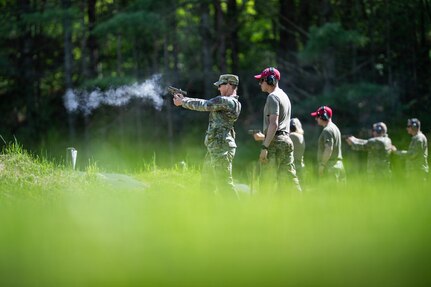 Photo of U.S. Air Force Command Chief Master Sgt. Jillian Rolla, the state command chief master sergeant for the Vermont National Guard, shooting a 9 mm Sig Sauer pistol at the Ethan Allen Firing Range in Jericho, Vermont.