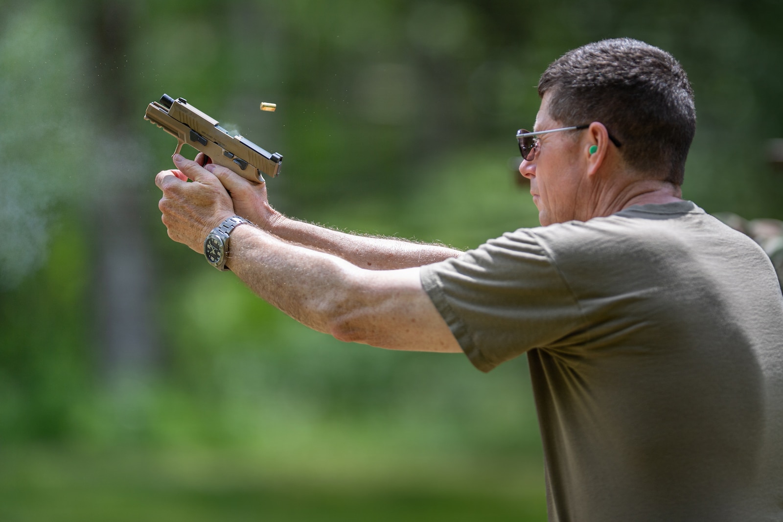 Photo of U.S. Air Force Maj. Gen. Henry Harder Jr., the adjutant general, Vermont National Guard, shooting his 9 mm Sig Sauer pistol at the Ethan Allen Firing Range in Jericho, Vermont.