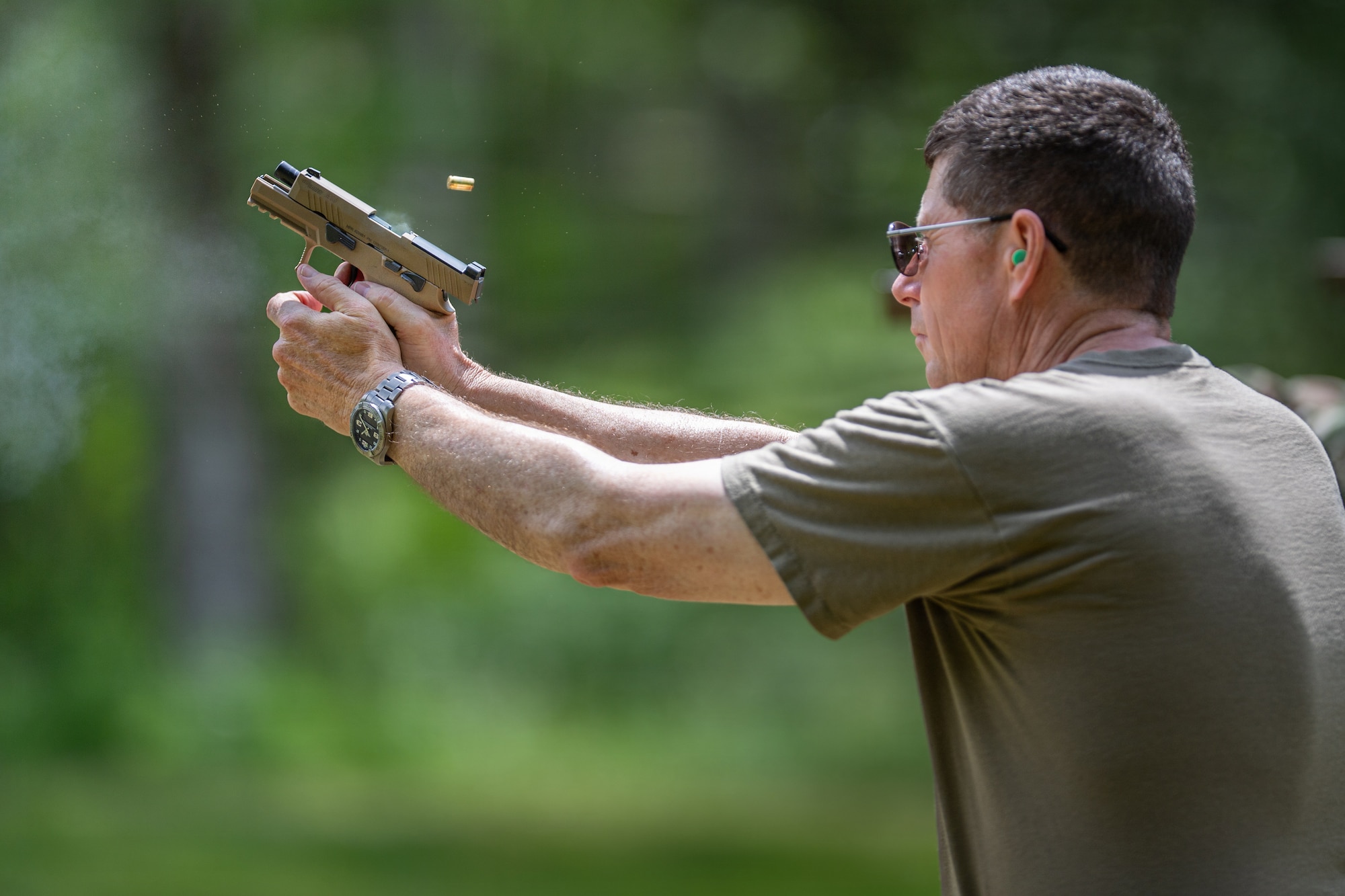 Photo of U.S. Air Force Maj. Gen. Henry Harder Jr., the adjutant general, Vermont National Guard, shooting his 9 mm Sig Sauer pistol at the Ethan Allen Firing Range in Jericho, Vermont.