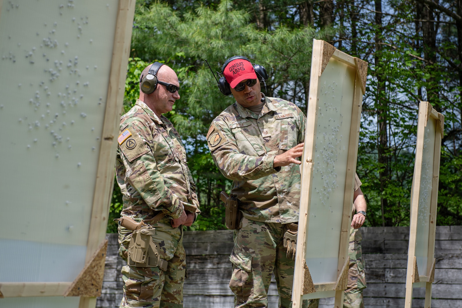 Photo of U.S. Army Brig. Gen. Matthew Brown, left, the director of the joint staff, chief of staff, Army, Vermont National Guard, checking his shot placement with U.S. Air Force Tech. Sgt. Trey Lytle, right, a combat arms instructor assigned to the 158th Security Forces Squadron, while qualifying on his weapon at the Ethan Allen Firing Range in Jericho, Vermont.