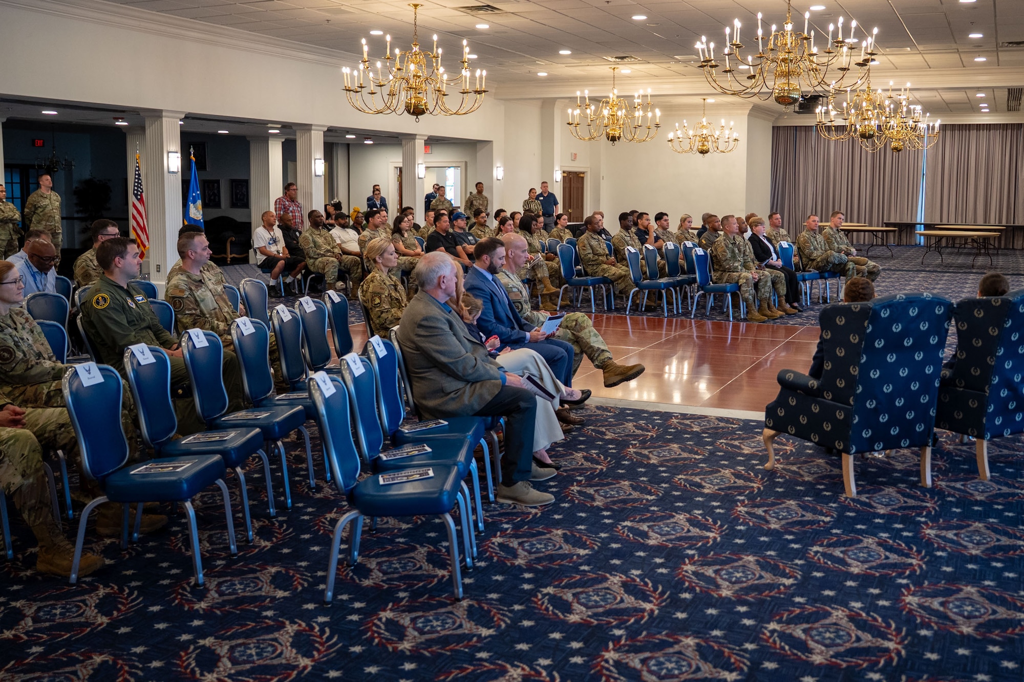 Attendees listen to remarks during change of command ceremony.