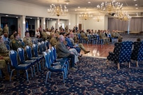 Attendees listen to remarks during change of command ceremony.