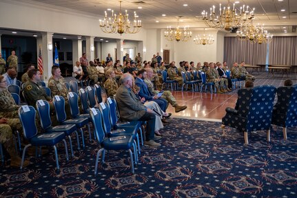 Attendees listen to remarks during change of command ceremony.