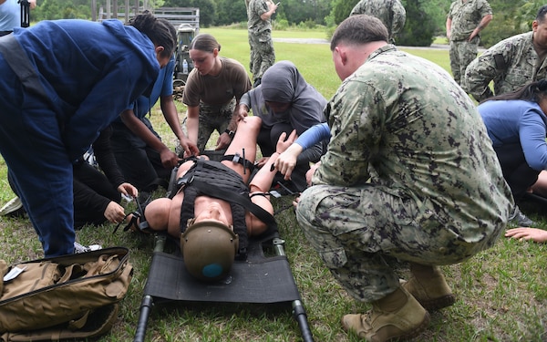 260609-N-JB216-5746 Jacksonville, Fla. (June 12, 2026) The annual Science, Service, Medicine, and Mentoring (S2M2) program at Naval Hospital Jacksonville concluded another impactful week!  From June 8-12, students from Darnell-Cookman School of the Medical Arts explored a variety of medical departments, gaining firsthand experience through hands-on activities, demonstrations, and mentorship from healthcare professionals. Students participated in Tactical Combat Casualty Care (TCCC), where they gained hands-on experience in lifesaving field medicine principles used in combat environments. (U.S. Navy photo by Kie Savage).