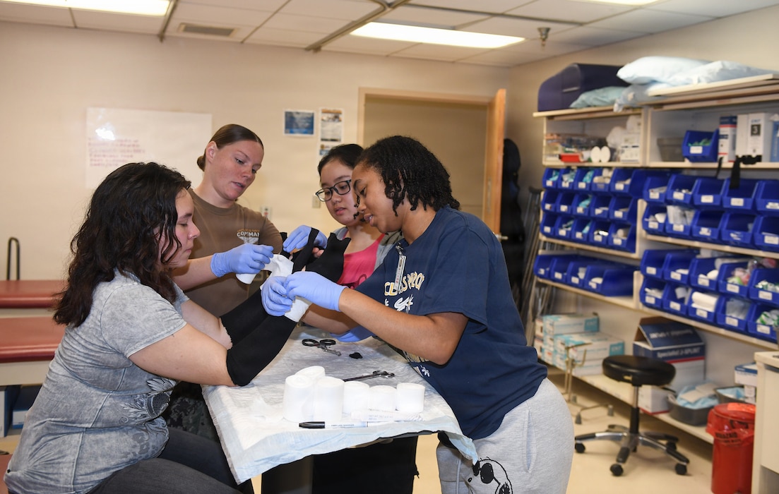 260610-N-JB216-7879 Jacksonville, Fla. (June 12, 2026) The annual Science, Service, Medicine, and Mentoring (S2M2) program at Naval Hospital Jacksonville concluded another impactful week!  From June 8-12, students from Darnell-Cookman School of the Medical Arts explored a variety of medical departments, gaining firsthand experience through hands-on activities, demonstrations, and mentorship from healthcare professionals. Students engaged in orthopedic splinting and casting stations, gaining practical experience in how injuries are stabilized and supported through proper application techniques. (U.S. Navy photo by Kie Savage).