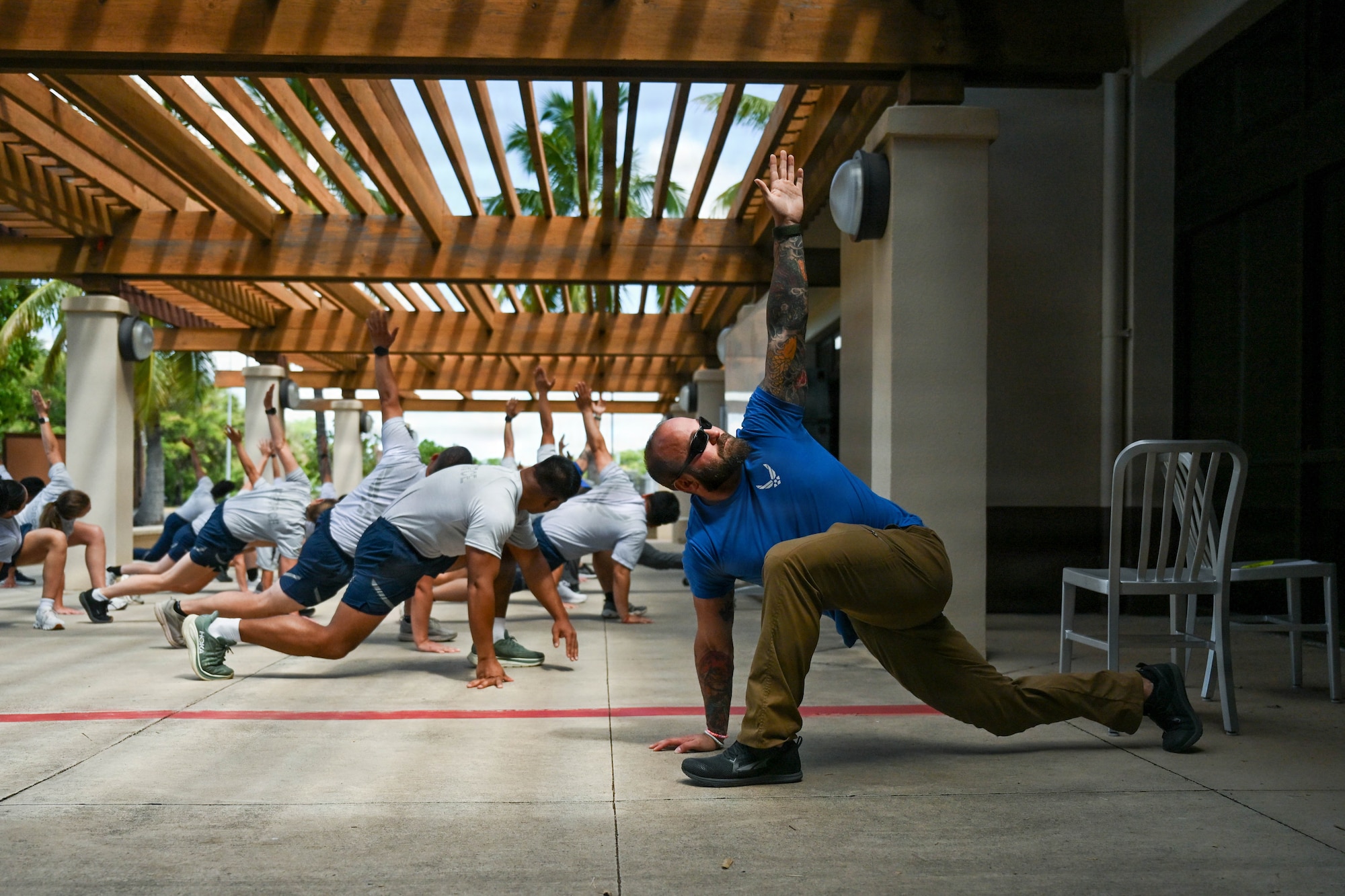 Lucas Rosa, Westover Air Reserve Base exercise physiologist, demonstrates a stretching technique during the Master Fitness Leader course at Joint Base Pearl Harbor-Hickam, June 11, 2026. Rosa was one of several instructors who taught the course, providing Airmen with education in exercise science, injury prevention and fitness program management to enhance overall readiness. (U.S. Air Force photo by Senior Airman Lauren Torres)