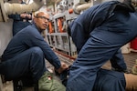 Hospital Corpsman 3rd Class Steward Cotui Mercedes checks vitals on a mock casualty during a casualty clearing drill in an engine room of the guided missile destroyer USS Donald Cook (DDG 75), Feb. 17, 2022. Cotui Mercedes now assigned to Naval Branch Health Clinic Mayport was recently named one of five hospital corpsmen in the Navy to be awarded the Danyelle Luckey Sacred Trust Award. (U.S. Navy photo by Mass Communication Specialist Seaman Nicholas M. Skyles)
