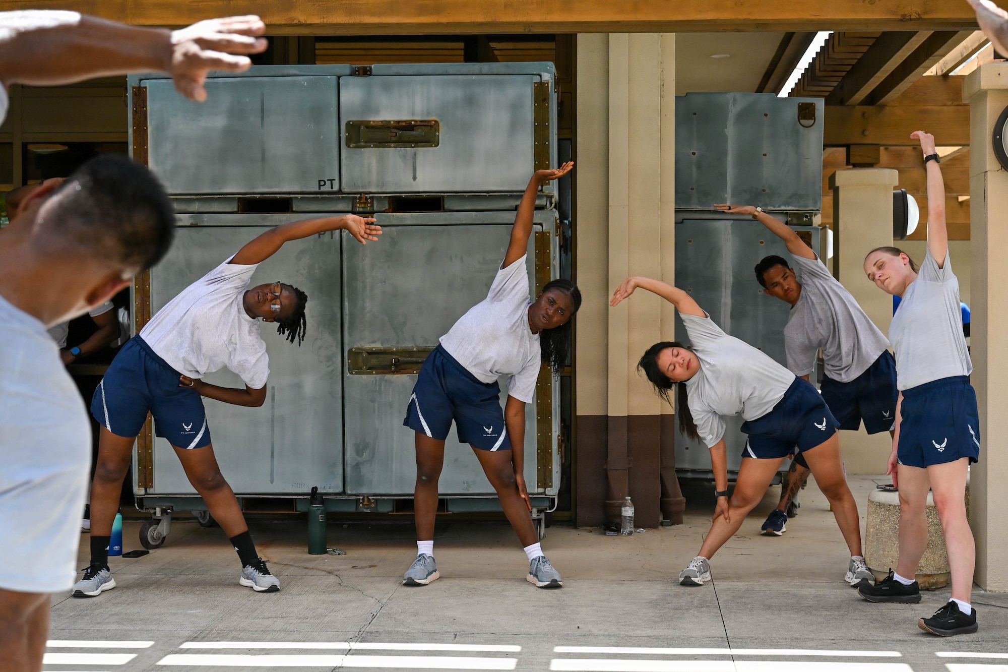 Airmen perform post-workout stretching during a Master Fitness Leader course at Joint Base Pearl Harbor-Hickam, June 11, 2026. Recovery techniques were incorporated throughout the course to help participants better understand injury prevention. (U.S. Air Force photo by Senior Airman Lauren Torres)