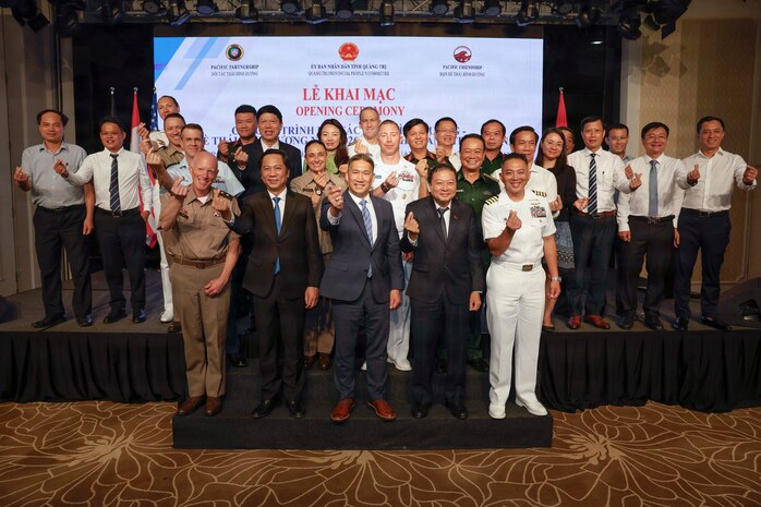 QUANG TRI, Vietnam (June 22, 2026) – Acting Secretary of the Navy Hung Cao, center, Mr. Le Hong Vinh, chairman of Quang Tri People’s Committee, center right, Mr. Hoang Nam, vice chairman of Quang Tri Province People’s Committee, center left, U.S. Army Maj. Gen. E. Darrin Cox, commander of the 18th Theater Medical Command and Army Forces assigned to Pacific Friendship 2026, front left, and U.S. Navy Capt. Robert Reyes, mission commander of Pacific Partnership 2026 (PP26), front right, and distinguished visitors pose for a photo during the PP26 Vietnam mission stop opening ceremony in Quang Tri, Vietnam, June 22, 2026.