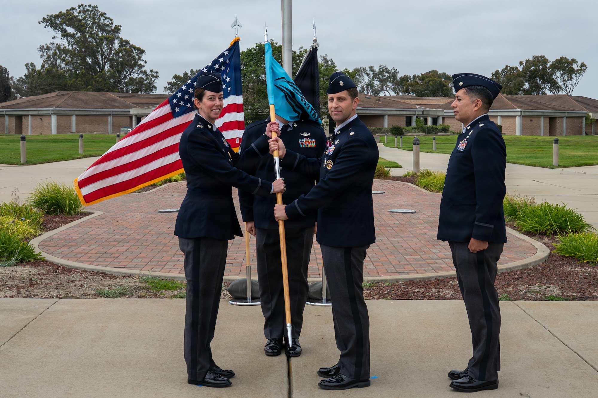 Two people hold a flag and stand