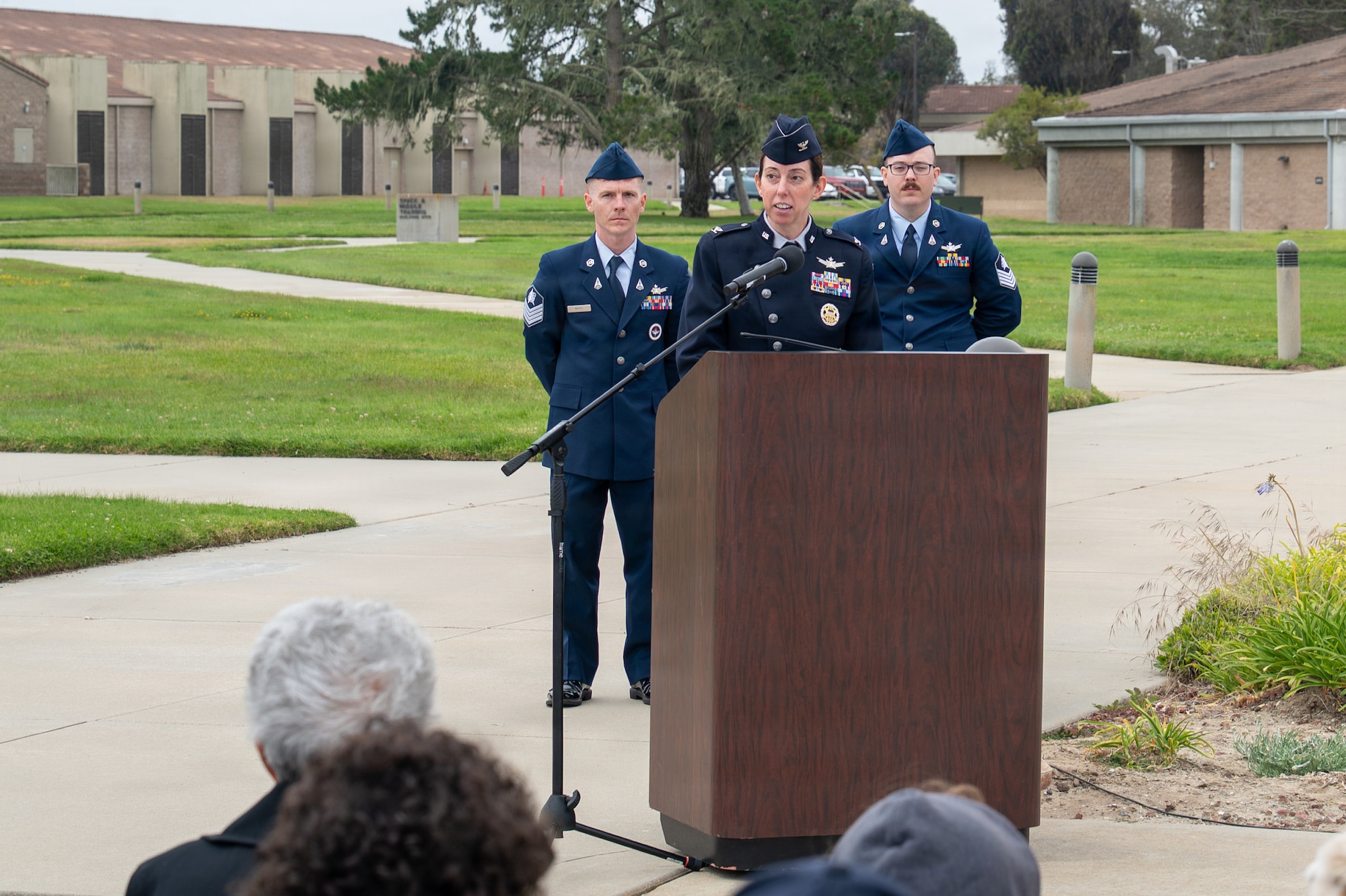 A person stands behind a podium and speaks