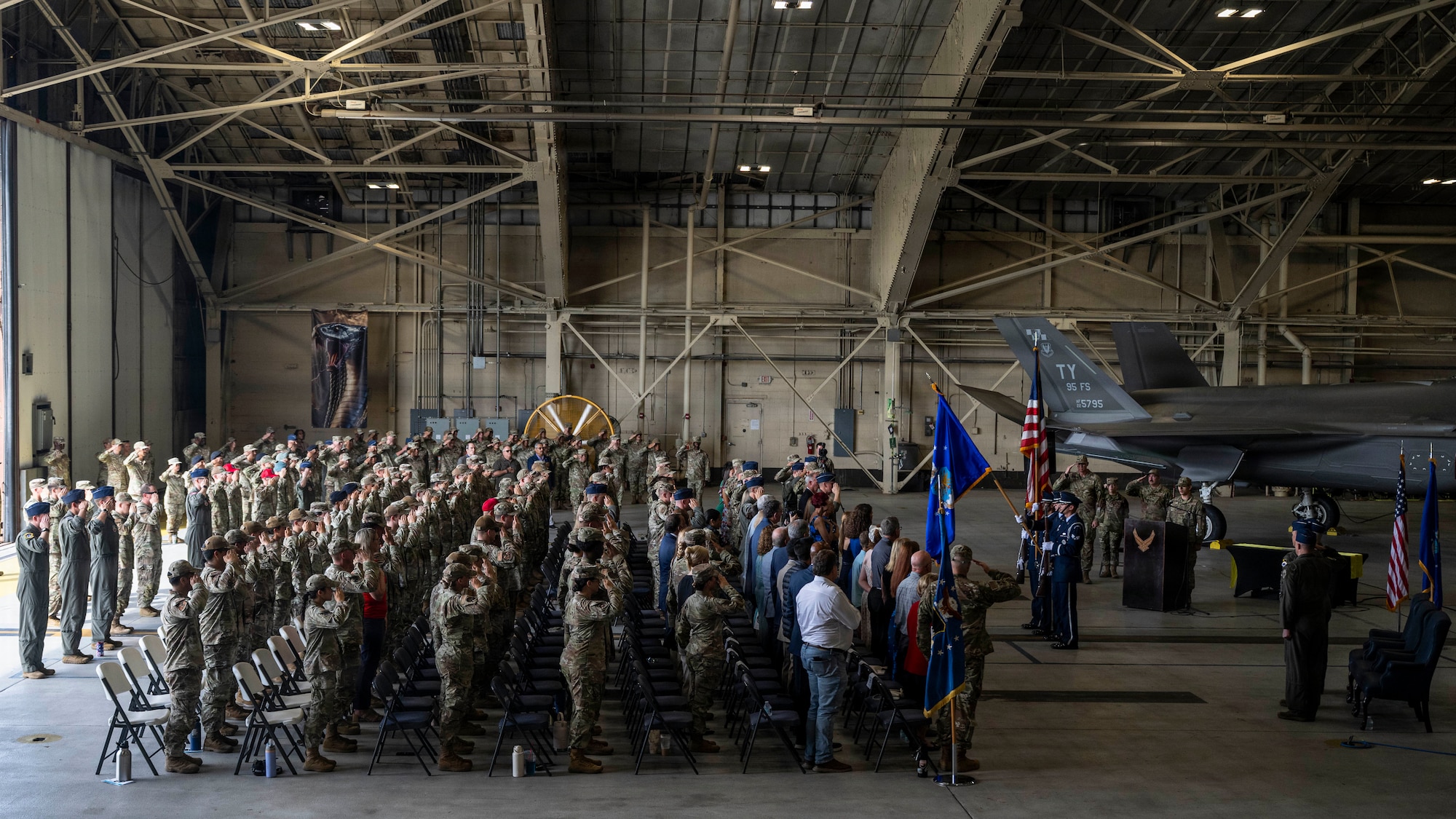 Audience members render honors during the playing of the national anthem at the 325th Fighter Wing change of command ceremony at Tyndall Air Force Base, Florida, June 23, 2026. As the installation transitions to host three operational F-35A Lightning II squadrons, the 325th Fighter Wing remains focused on its core mission of delivering lethal, agile and ready global airpower, anywhere and anytime. (U.S. Air Force photo by Tech. Sgt. Charles Welty)