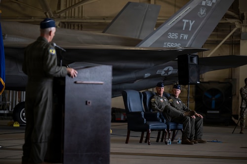 U.S. Air Force Maj. Gen. Steven Behmer, Fifteenth Air Force commander, delivers opening remarks as Col. Christian M. Bergtholdt and Col. Ryan C. Thulin, 325th Fighter Wing outgoing and incoming commander, respectively, look on during the wing’s change of command ceremony at Tyndall Air Force Base, Florida, June 23, 2026. During his remarks, Behmer praised Bergtholdt for his steady leadership through Tyndall's ongoing transformation and expressed absolute confidence in Thulin’s ability to take the helm. (U.S. Air Force photo by Tech. Sgt. Charles Welty)
