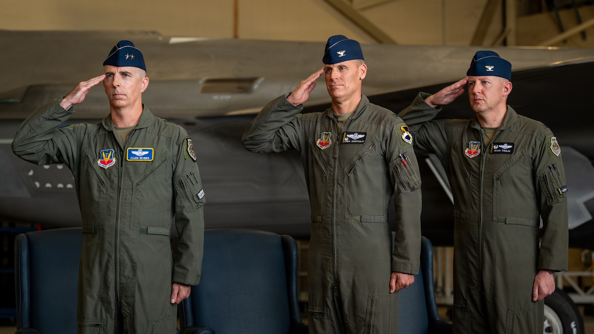 U.S. Air Force Maj. Gen. Steven Behmer, Fifteenth Air Force commander, Col. Christian Bergtholdt, 325th Fighter Wing commander, and Col. Ryan Thulin, 33rd Operations Group commander, render a salute during the playing of the national anthem at the 325th FW change of command ceremony at Tyndall Air Force Base, Florida, June 23, 2026. Behmer presided over the ceremony, which formally transferred command of the 325th FW from Bergtholdt to Thulin. (U.S. Air Force photo by Senior Airman Amanda Alvarez)