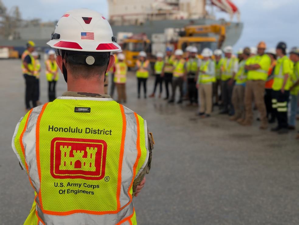USACE Engineer faces group during morning roll call.
