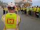 USACE Engineer faces group during morning roll call.