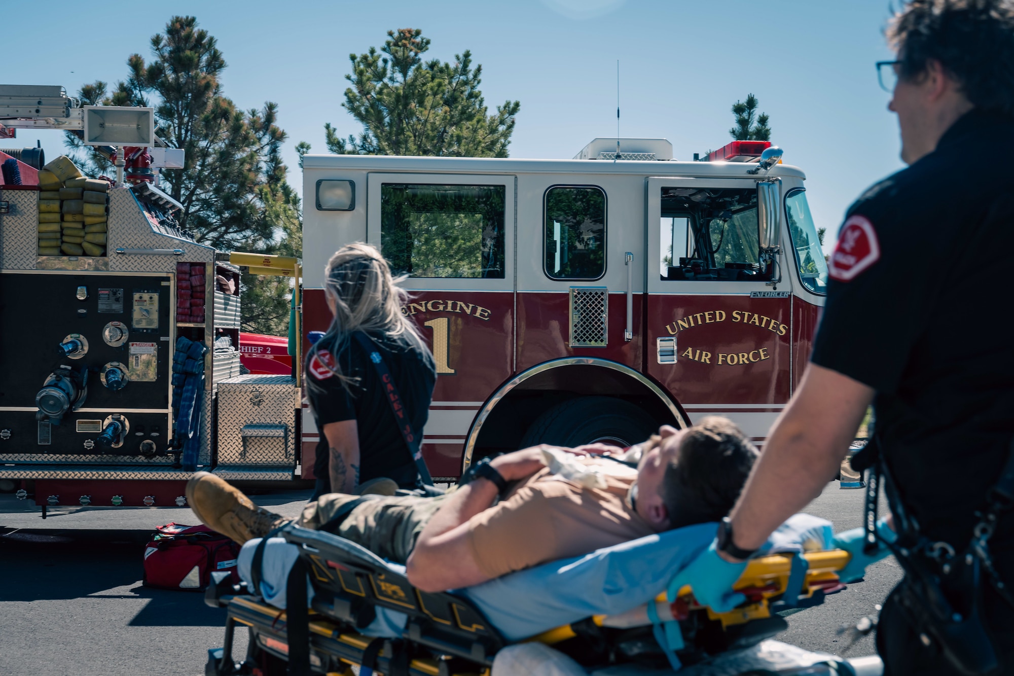 two paramedics push a stretcher with a person on it