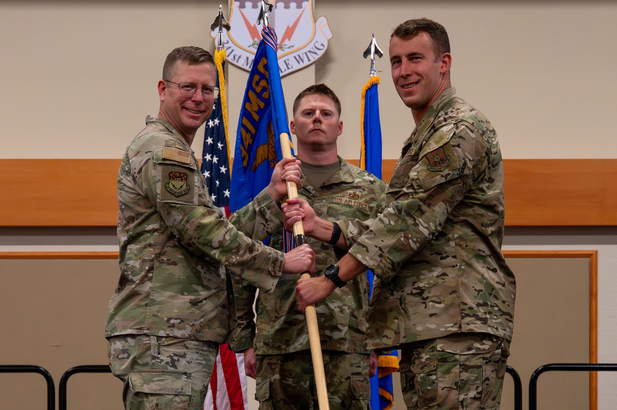 U.S. Air Force Maj. Aaron Quick, right, accepts command of the 341st Contracting Squadron from Col. Brian Low, 341st Mission Support Group commander, during a change of command at Malmstrom Air Force Base, Montana, June 23, 2026.