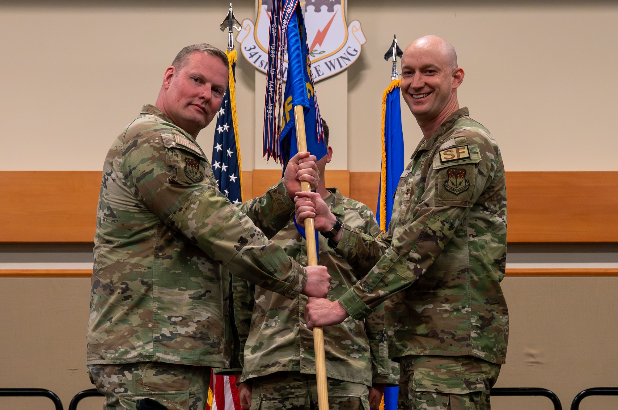 U.S. Air Force Maj. Ian A. Latham, right, accepts command of the 341st Missile Security Forces Squadron from Col. Drew Gehler, 341st Security Forces Group commander, during a change of command at Malmstrom Air Force Base, Montana, June 23, 2026.