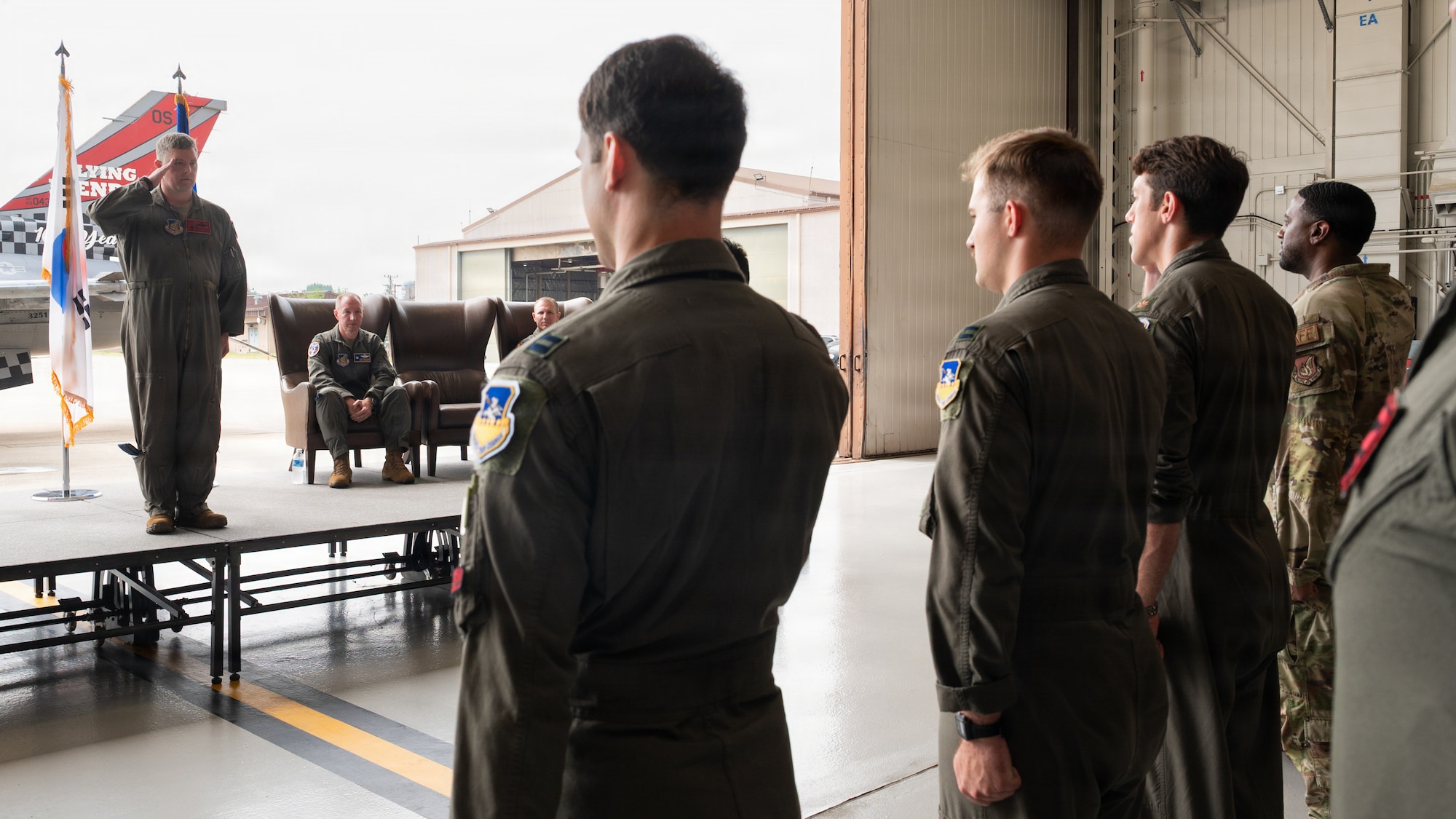 A squadron salutes their commander.